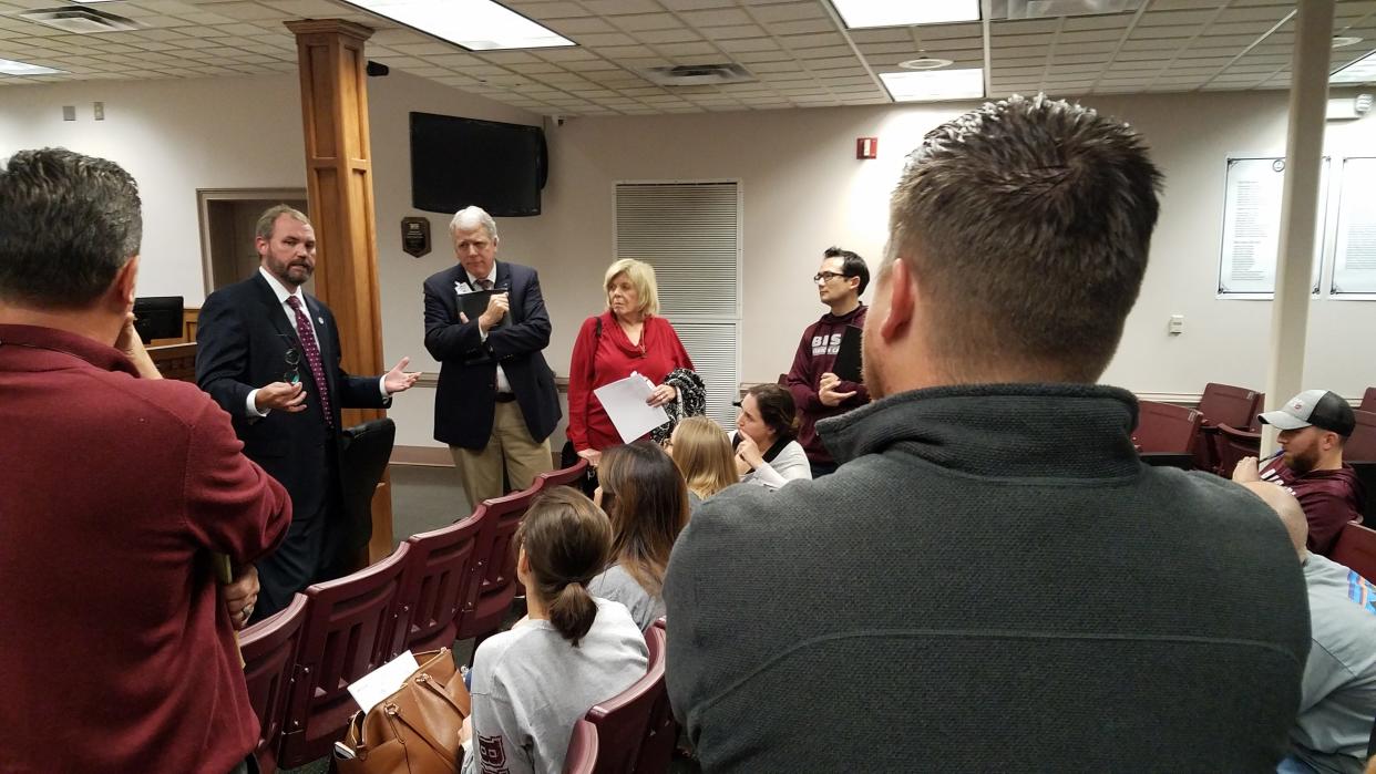 Sumner County Director of Schools Del Phillips and school board members Jim Hawkins and Patricia Brown, far right in red, speak at a community meeting in 2018.