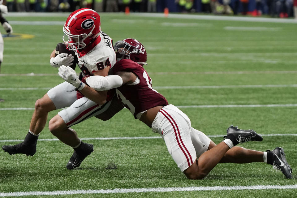 Georgia wide receiver Ladd McConkey (84) catches the ball against Alabama defensive back Malachi Moore (13) during the second half of the Southeastern Conference championship NCAA college football game in Atlanta, Saturday, Dec. 2, 2023. (AP Photo/Mike Stewart)