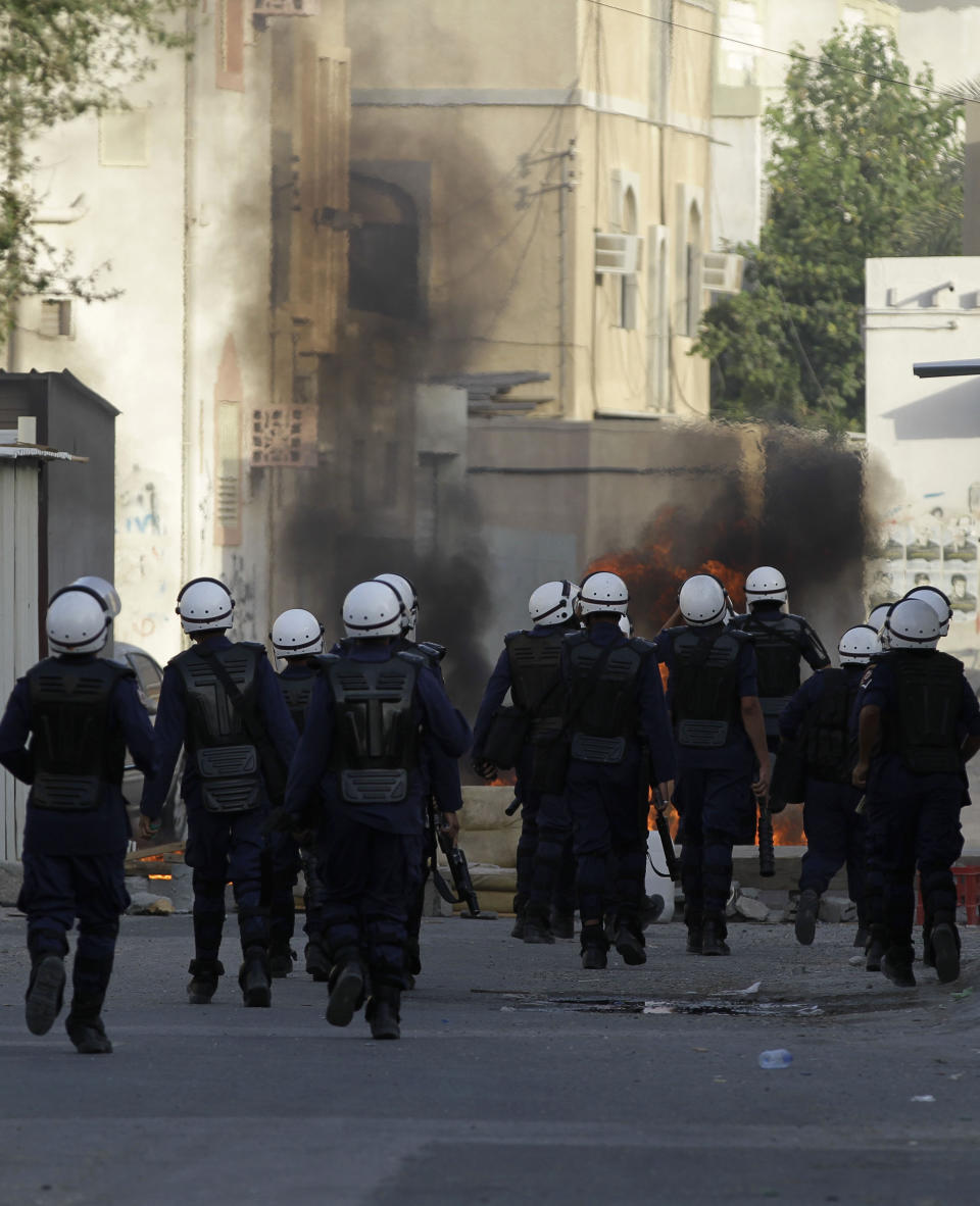 Riot police fire tear gas toward Bahraini anti-government protesters throwing petrol bombs during clashes after a march to recognize protesters who have lost their vision after being shot in the eye with bird shot, rubber bullets or tear gas canisters during past clashes Thursday, June 7, 2012, in Sitra, Bahrain. (AP Photo/Hasan Jamali)