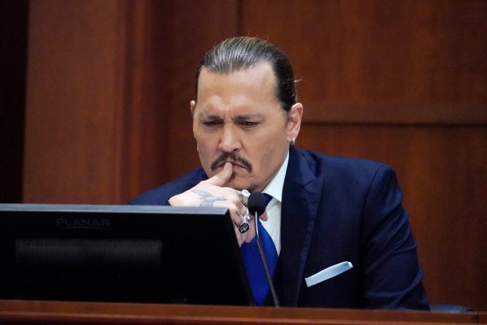 Johnny Depp testifies at the Fairfax County Courthouse in Fairfax, Virginia on 25 April 2022 (STEVE HELBER/POOL/AFP via Getty Images)