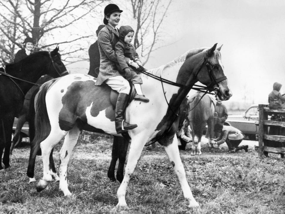Jackie and Caroline Kennedy riding a horse in 1963