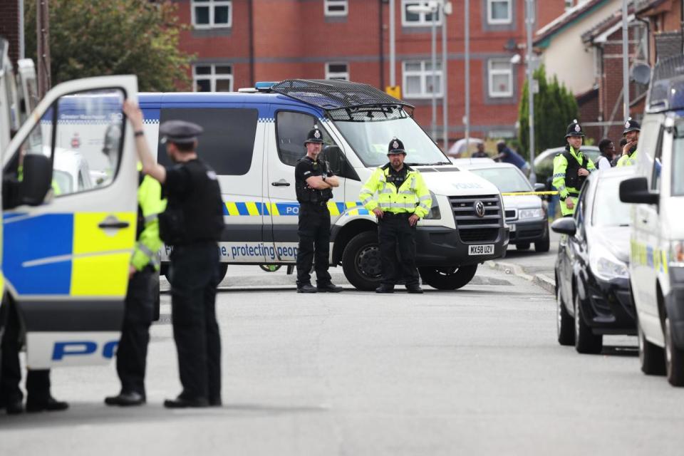 Police activity at a cordon in Selworthy Road near to Quantock Street, Moss Side (PA)