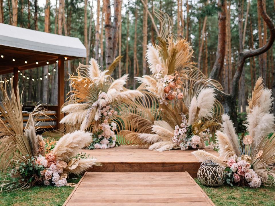 Pampas grass wedding arch surrounding altar