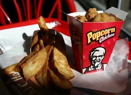 An order of french fries and chicken sit on a tray at a KFC fast food restaurant in New York October 30, 2006. REUTERS/Shannon Stapleton