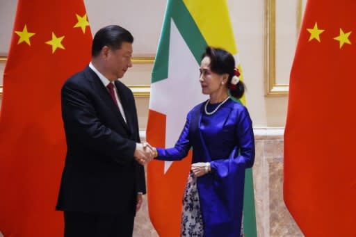 Chinese President Xi Jinping is on visit aimed at buttressing the government of Aung San Suu Kyi (R) as Myanmar reels from Western isolation over the Rohingya crisis