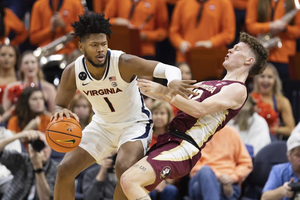 Virginia's Jayden Gardner (1) commits a foul against Florida during the first half of an NCAA college basketball game in Charlottesville, Va., Saturday, Dec. 3, 2022. (AP Photo/Mike Kropf)