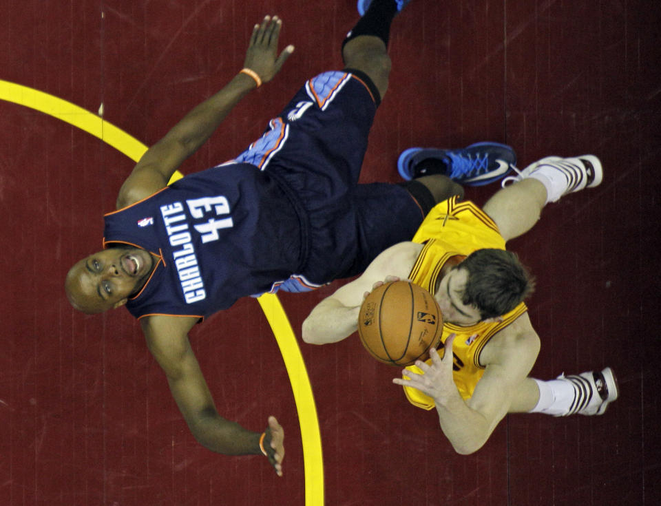 Charlotte Bobcats' Anthony Tolliver (43) is knocked down by Cleveland Cavaliers' Tyler Zeller in the first half of an NBA basketball game on Saturday, April 5, 2014, in Cleveland. (AP Photo/Mark Duncan)