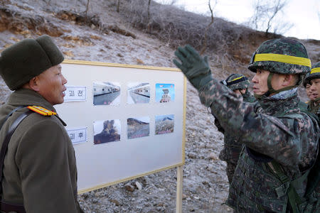 Soldiers from North and South Korea verify the removal of guard posts on each side of the Demilitarized Zone, December 12, 2018. South Korean Defence Ministry/Handout via REUTERS
