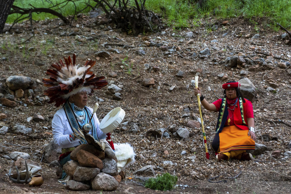 Havasupai ceremonial practitioner Uqualla, left, and tribal member Kris Siyuja, hold a blessing ceremony below the rim at Grand Canyon National Park on Friday, May 5, 2023. The Havasupai Tribe and the park marked the renaming of a popular campground from Indian Garden to Havasupai Gardens. (AP Photo/Ty O'Neil)