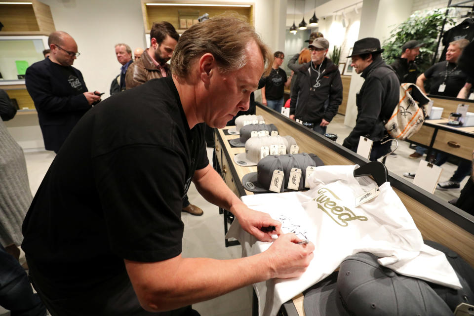 Canopy Growth CEO Bruce Linton autographs a t-shirt after legal recreational marijuana went on sale at a Tweed retail store in St John's, Newfoundland and Labrador, Canada October 17, 2018. REUTERS/Chris Wattie