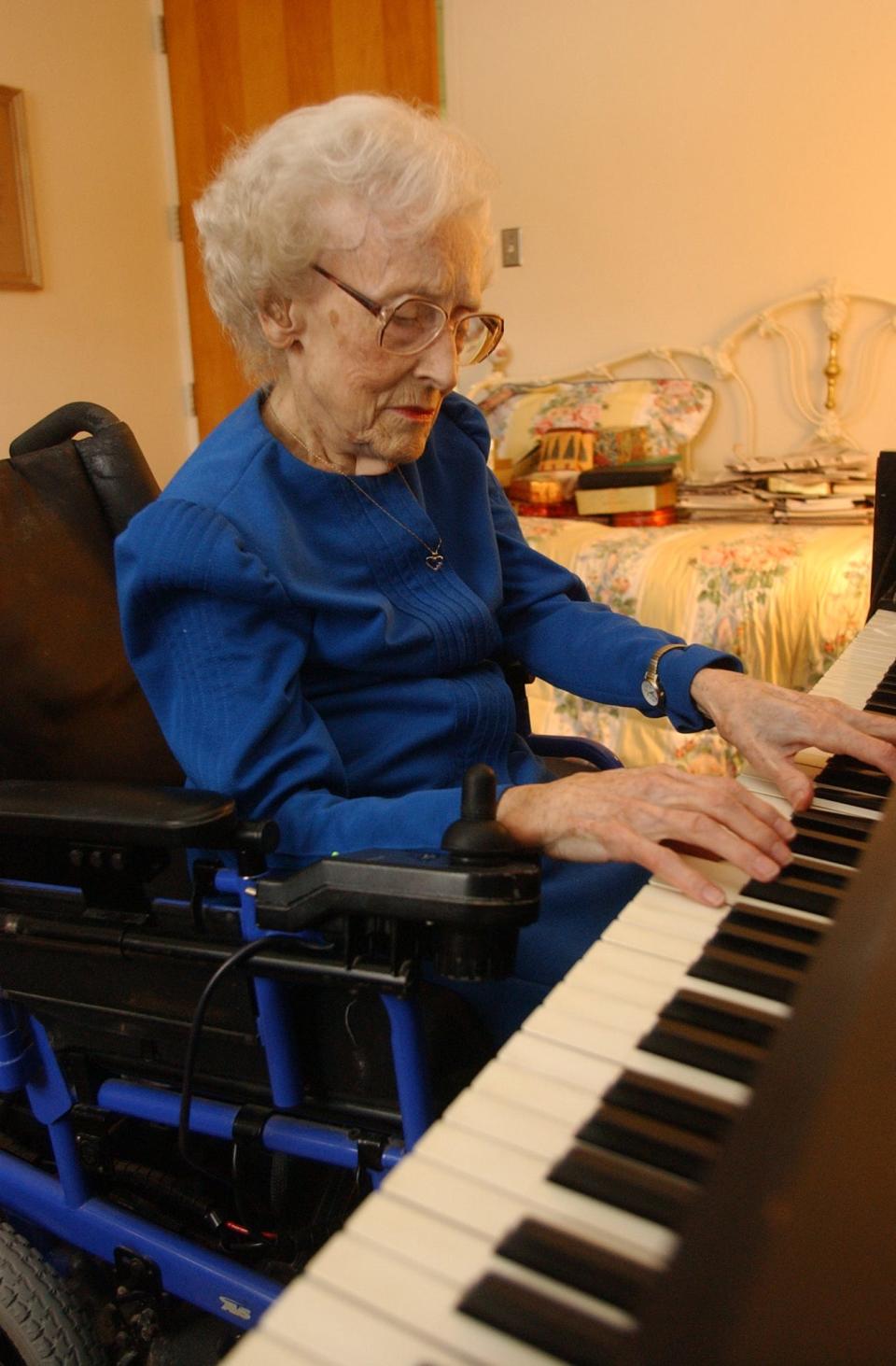 Evelyn Miller, age 94, is photographed in 2004 with the piano in her room at Shannondale, where she usually practiced for four hours a day.