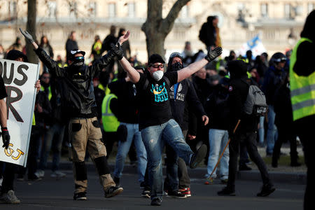 FILE PHOTO: Protesters clash with French riot police near the Invalides during a demonstration by the "yellow vests" movement in Paris, France, February 16, 2019. REUTERS/Benoit Tessier/File Photo