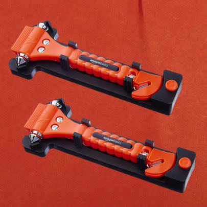 A pair of emergency seat belt cutters and window hammers