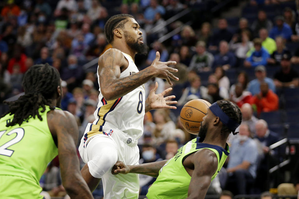 New Orleans Pelicans forward Naji Marshall (8) is called for a charge with defense from Minnesota Timberwolves guard Patrick Beverley, right, in the first half of an NBA basketball game, Saturday, Oct. 23, 2021, in Minneapolis. (AP Photo/Andy Clayton-King)