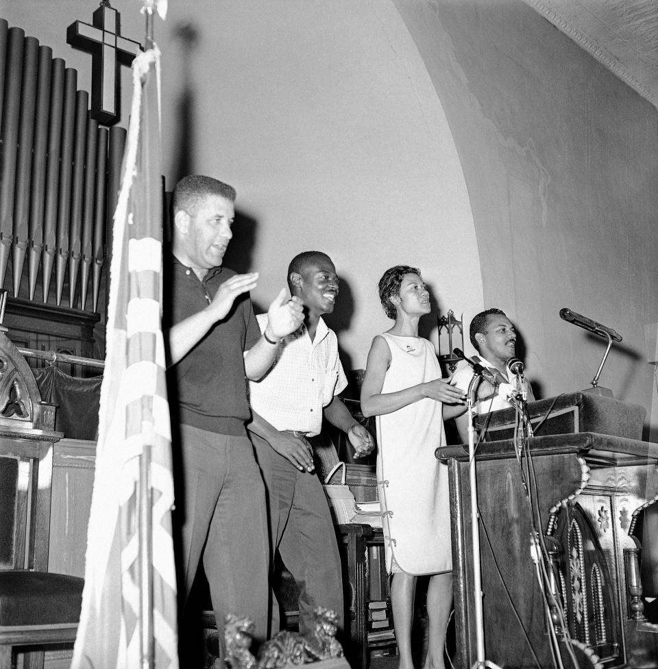 Leaders of the demonstrations lead a crowd in singing freedom songs at a mass meeting in the Bethel AME Church in Cambridge, Md., July 23, 1963. The meeting was called to explain the agreement signed in Washington to end the racial impasse. From left are Stanley Branche, National Association for the Advancement of Colored People, Reginald Robinson, Student Non-Violent Coordinating, Gloria Richardson, Cambridge Non-Violent Action Committee, and Phillip H. Savage, NAACP. (AP Photo/William A. Smith)