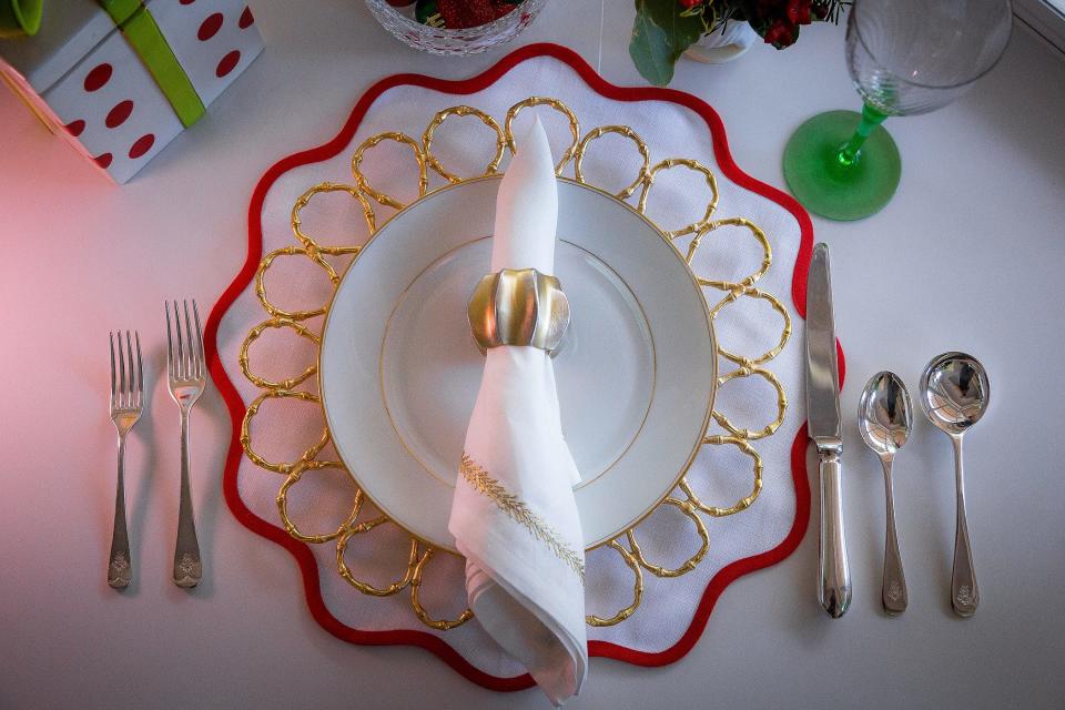 A holiday place setting showing the charger and the plate with napkin setting at the home of Penny Murphy in Lake Clarke Shores.