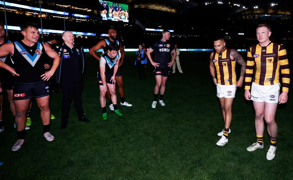 Hawthorn and Port Adelaide players alongside Ken Hinkley.