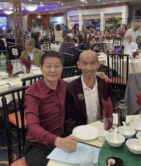 This photo provided by Peter Phung shows Phung, right, and Ming Wei Ma in January 2022 at a seafood restaurant in Rosemead, Calif. Ma was one of 11 people killed when a gunman opened fire on Saturday, Jan. 21, 2023, at the Star Ballroom Dance Studio, a dance hall in Monterey Park, Calif., that is popular with older Asian Americans. Ma was the manager of the ballroom. (Peter Phung via AP)