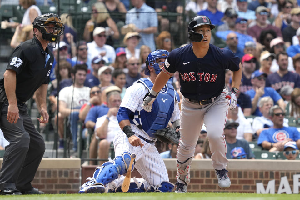 Boston Red Sox's Masataka Yoshida, right, of Japan, watches his grand slam during the fifth inning of a baseball game against the Chicago Cubs in Chicago, Sunday, July 16, 2023. (AP Photo/Nam Y. Huh)