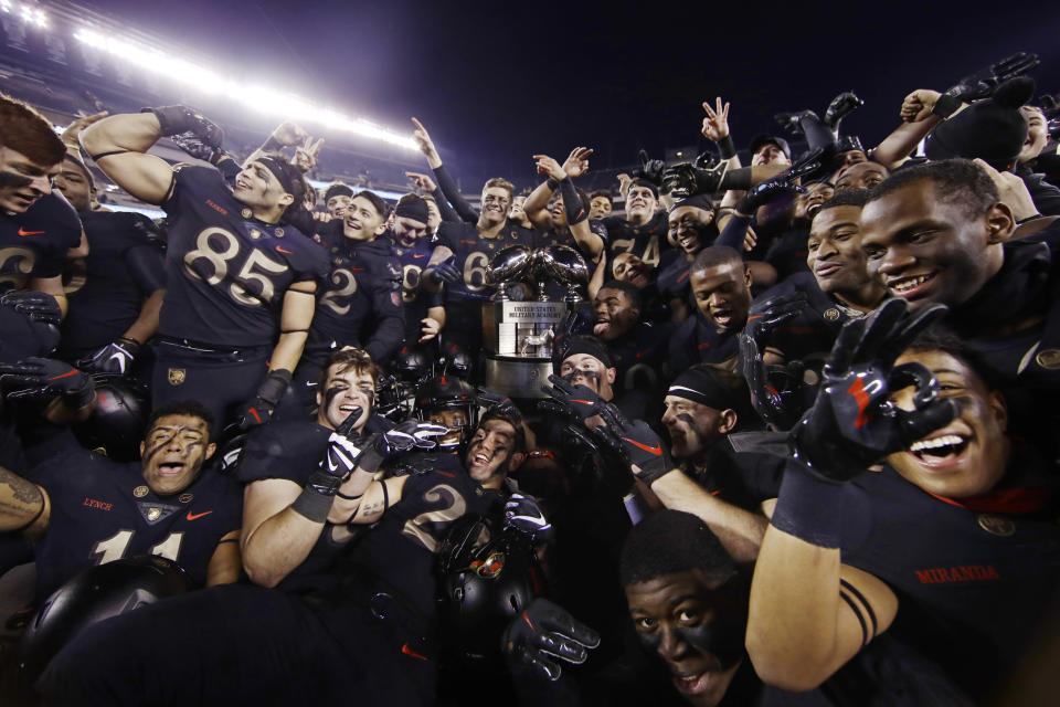 Army players celebrate with the Commander in Chief's trophy following a 17-10 victory over Navy in an NCAA college football game, Saturday, Dec. 8, 2018, in Philadelphia. Army won 17 -10. (AP Photo/Matt Rourke)