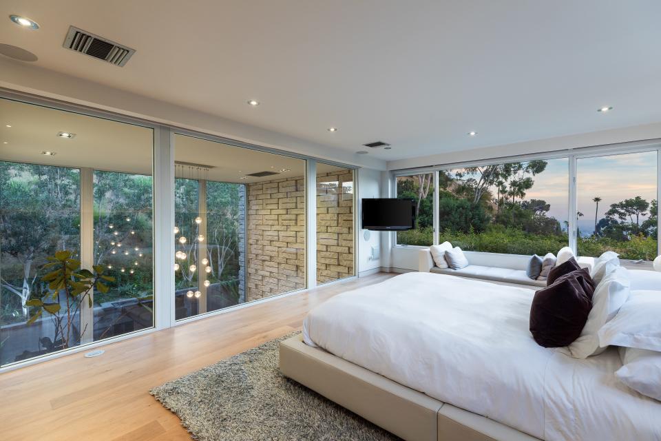 The unique master bedroom, which is lined with windows.