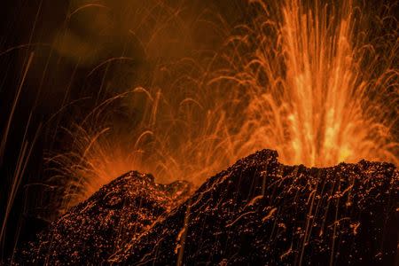 Molten lava erupts from the Piton de la Fournaise, one of the world's most active volcanoes, in this picture taken July 31, 2015, on French Indian Ocean Reunion Island. REUTERS/Gilles Adt