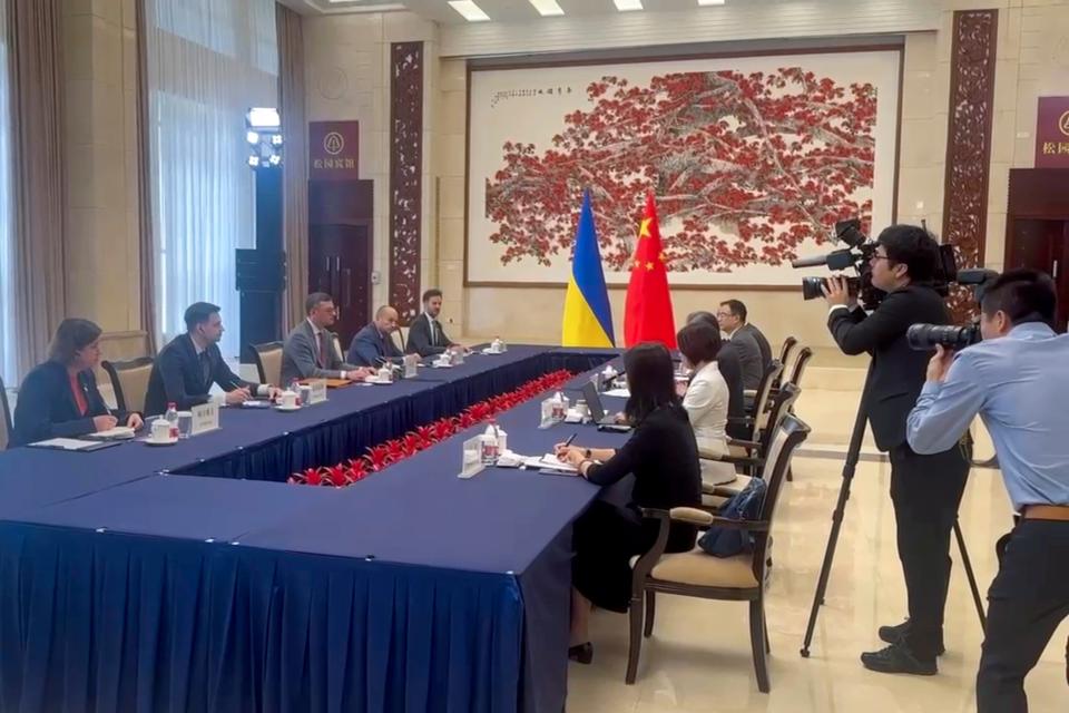 In this image taken from video released by the Ukraine Ministry of Foreign Affairs, Ukraine's Foreign Ministry Dmytro Kuleba, third from left holds talks with China's Foreign Minister Wang Yi at a meeting in the southern Chinese city of Guangzhou (AP)