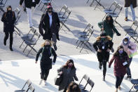 People evacuate from the West Front of the U.S. Capitol during a rehearsal the 59th Presidential Inauguration at the U.S. Capitol in Washington, Monday, Jan. 18, 2021. (AP Photo/Carolyn Kaster)