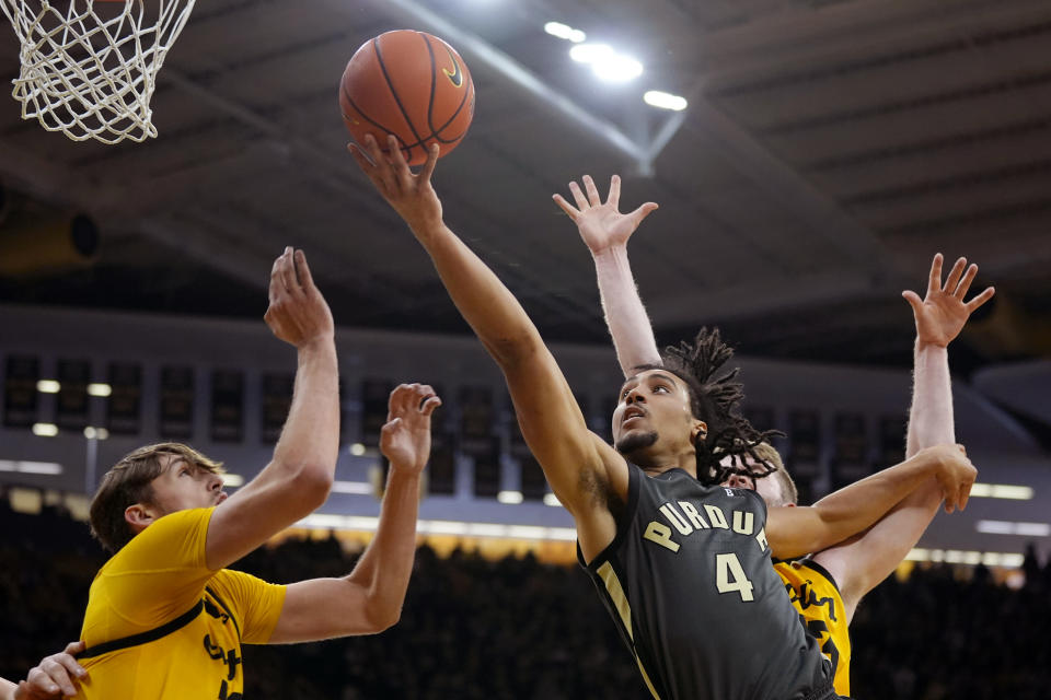 Purdue forward Trey Kaufman-Renn (4) drives to the basket over Iowa forward Owen Freeman, left, during the first half of an NCAA college basketball game, Saturday, Jan. 20, 2024, in Iowa City, Iowa. (AP Photo/Charlie Neibergall)