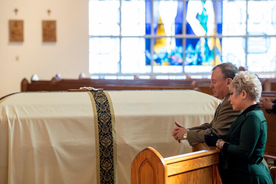 Andrew McVeigh and Amy McVeigh pray during a funeral mass for Lt. John Heffernan at St. Elizabeth of Hungary RC Church in Wyckoff, NJ on Saturday, November 19, 2022. Heffernan is a WWII U.S. bomber navigator who was shot down in Burma in 1944. Heffernan's remains were identified in 2021 and returned to the U.S. 78 years after his death. Andrew McVeigh is HeffernanÕs nephew. 