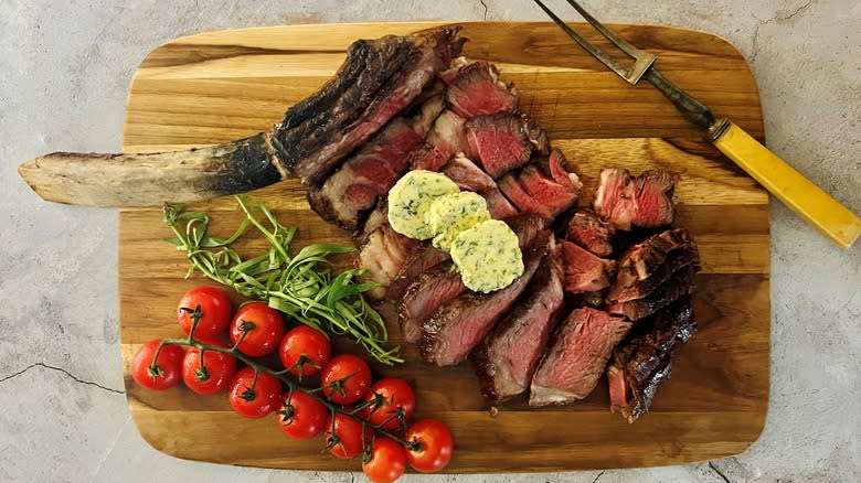 tomahawk steak with butter and fork