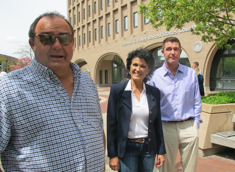 In this Thursday, May 8, 2014 photo, from left, Larry Harvey, Rhonda Firestack-Harvey, and Rolland Gregg stand in the plaza in front of the federal courthouse in Spokane, Wash. The three are charged with growing marijuana at a remote farm near Kettle Falls, Wash. Each face mandatory minimum sentences of at least 10 years in prison after they were caught growing about 70 pot plants on their rural, mountainous property. Medical marijuana advocates have cried foul, arguing the prosecution violates Department of Justice policies announced by Attorney General Eric Holder last year that nonviolent, small-time drug offenders shouldn't face lengthy prison sentences. (AP Photo/Nicholas K. Geranios)