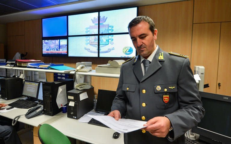 An officer of the Guardia di Finanzia reads a report in a regional command centre on November 20, 2012 in Rome. Police man the phones 24/7, receiving a flood of reports from citizens against tax dodgers -- from landlords failing to declare their rental income to shopkeepers and waiters failing to provide receipts