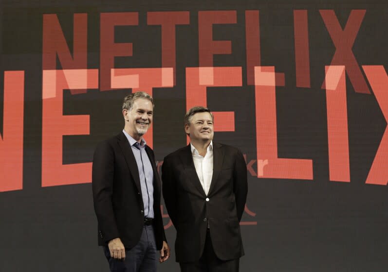 FILE - In this Thursday, June 30, 2016, file photo, Netflix CEO Reed Hastings, left, poses with Ted Sarandos, chief content officer of Netflix, during a news conference in Seoul, South Korea. Netflix added a flood of new subscribers amid the coronavirus pandemic and also offered clues to a possible successor for founding CEO Hastings, who on Thursday, July 16, 2020, named Sarandos, as co-CEO. (AP Photo/Ahn Young-joon, File)