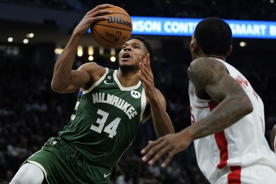 Milwaukee Bucks' Giannis Antetokounmpo looks to shoot past Houston Rockets' Kevin Porter Jr. during the second half of an NBA basketball game Saturday, Oct. 22, 2022, in Milwaukee. (AP Photo/Morry Gash)