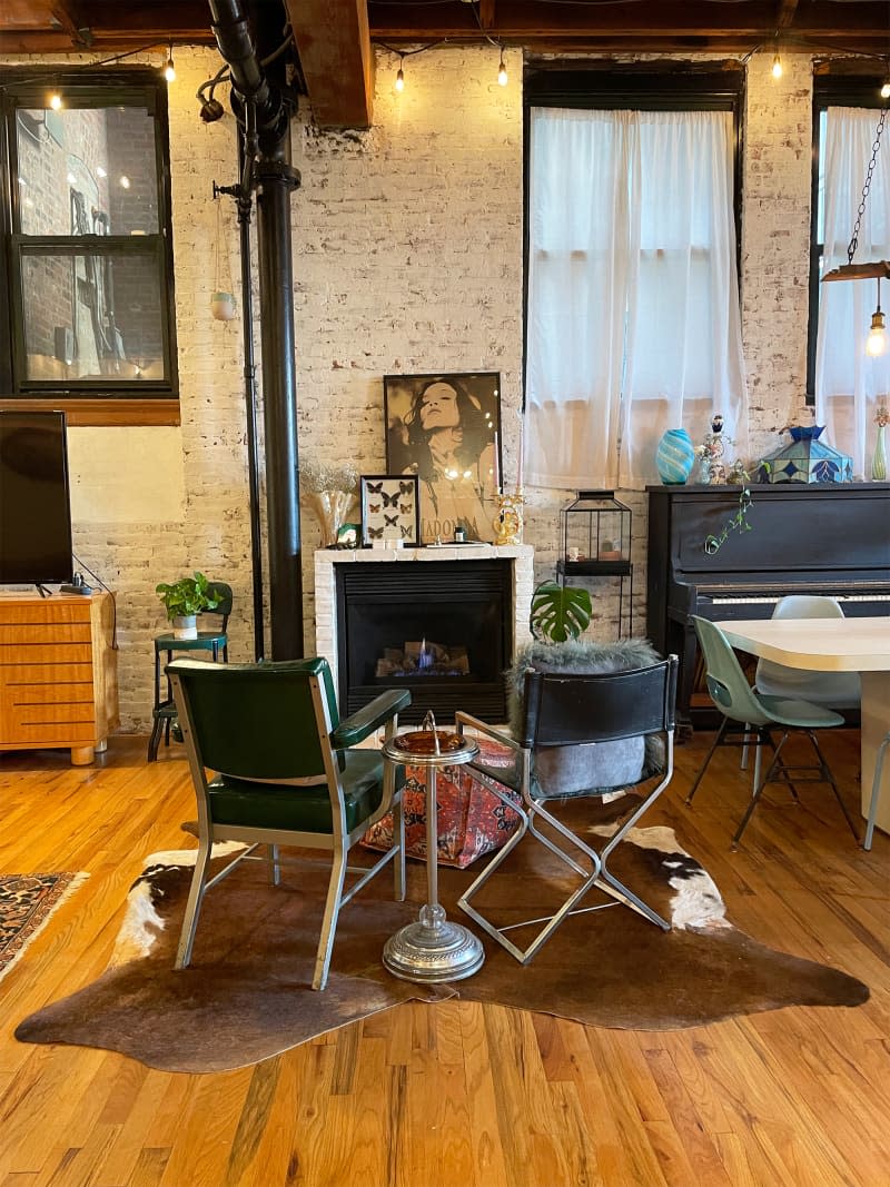 Arm chairs in front of fireplace in loft apartment.