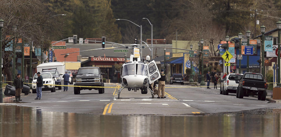 A CHP helicopter uses Main Street in Guerneville, Calif. as a landing pad as water continues to rise, Feb. 27, 2019. (Photo: Kent Porter/The Press Democrat via AP)