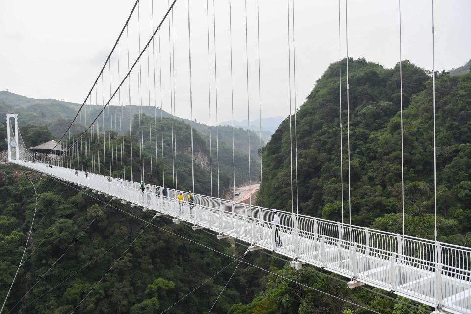 people walk on the Bach Long glass bridge in the Moc Chau district in Vietnam's Son La province