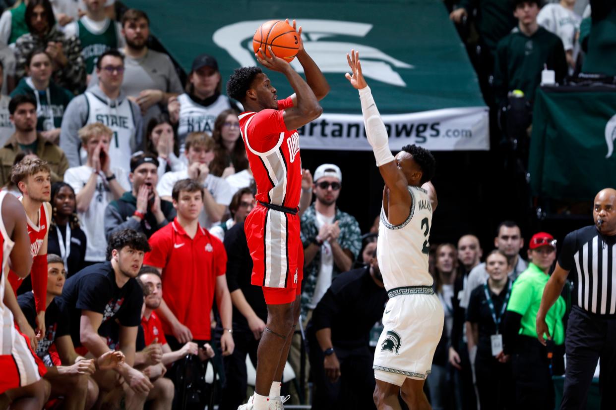 Ohio State guard Dale Bonner, center left, shoots the winning 3-point basket against Michigan State guard Tyson Walker (2) during the closing seconds of the second half at Breslin Center in East Lansing on Sunday, Feb. 25, 2024.