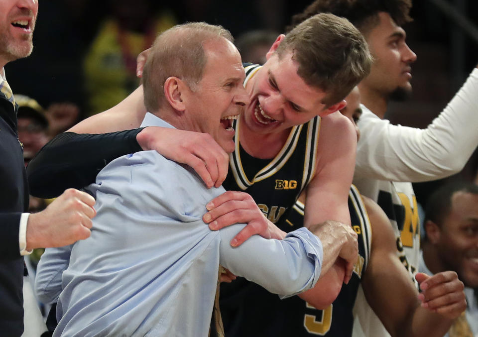 Michigan head coach John Beilein, left, celebrates with Michigan forward Moritz Wagner (13) after Michigan defeated Purdue 75-66 to win the Big Ten tournament. (AP Photo/Julie Jacobson)