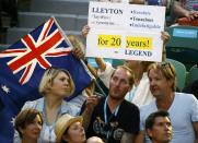 Supporters of Australia's Lleyton Hewitt hold flags and signs during his first round match against compatriot James Duckworth at the Australian Open tennis tournament at Melbourne Park, Australia, January 19, 2016. REUTERS/Thomas Peter