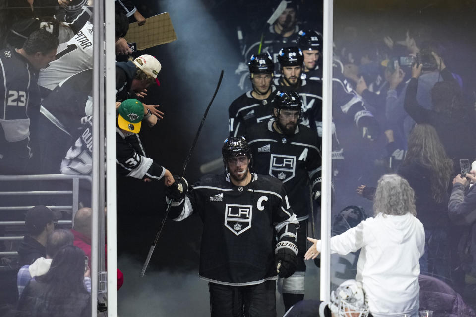 Los Angeles Kings center Anze Kopitar (11) enters the ice before the third period of a preseason NHL hockey game against the Anaheim Ducks Tuesday, Oct. 3, 2023, in Los Angeles. (AP Photo/Ashley Landis)