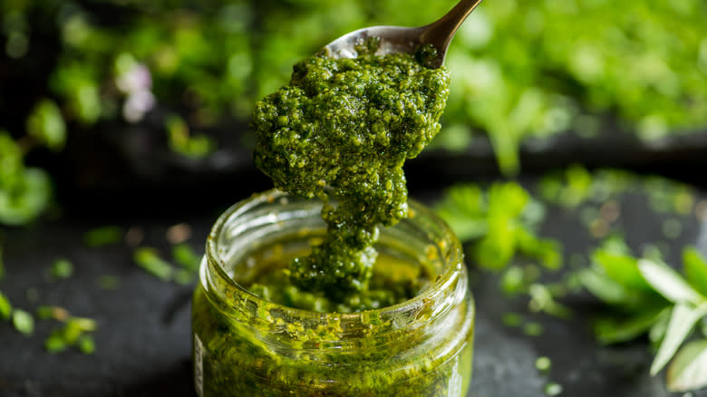 pesto spooned from jar