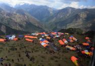 Local residents gather near their makeshift tents in Laprak village, Nepal's Gorkha district, on May 4, 2015