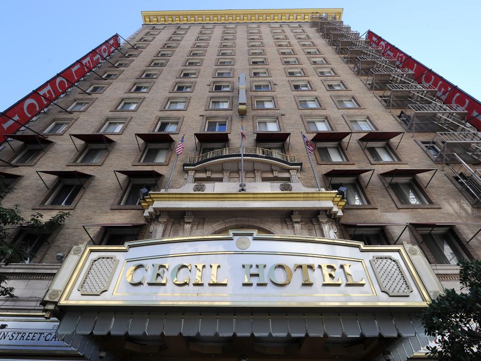 View of hotel from the ground up showing Cecil Hotel awning and windows to the top of the building.