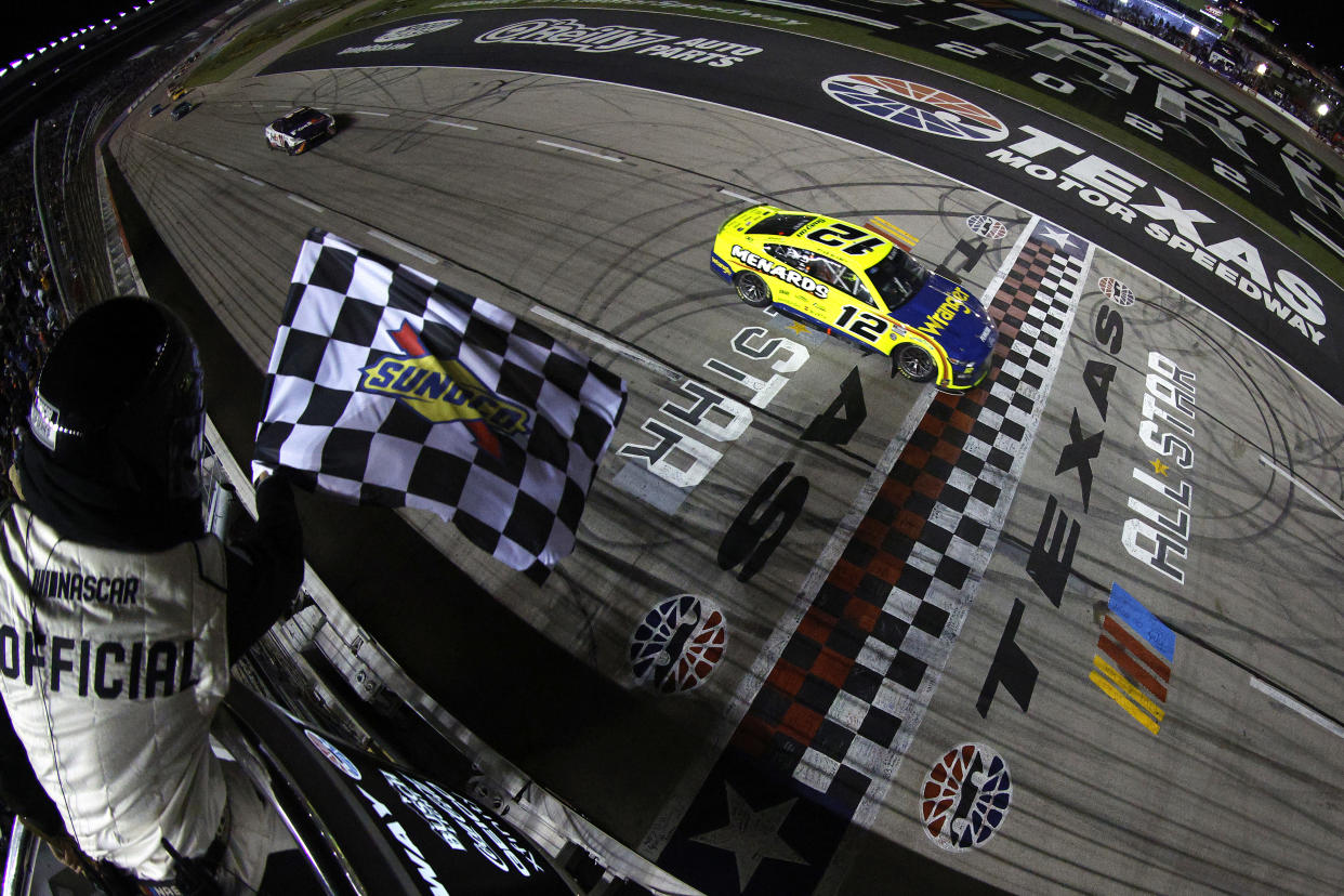 FORT WORTH, TEXAS - MAY 22: Ryan Blaney, driver of the #12 Menards/Wrangler Ford, takes the checkered flag to win the NASCAR Cup Series All-Star Race at Texas Motor Speedway on May 22, 2022 in Fort Worth, Texas. (Photo by Sean Gardner/Getty Images)