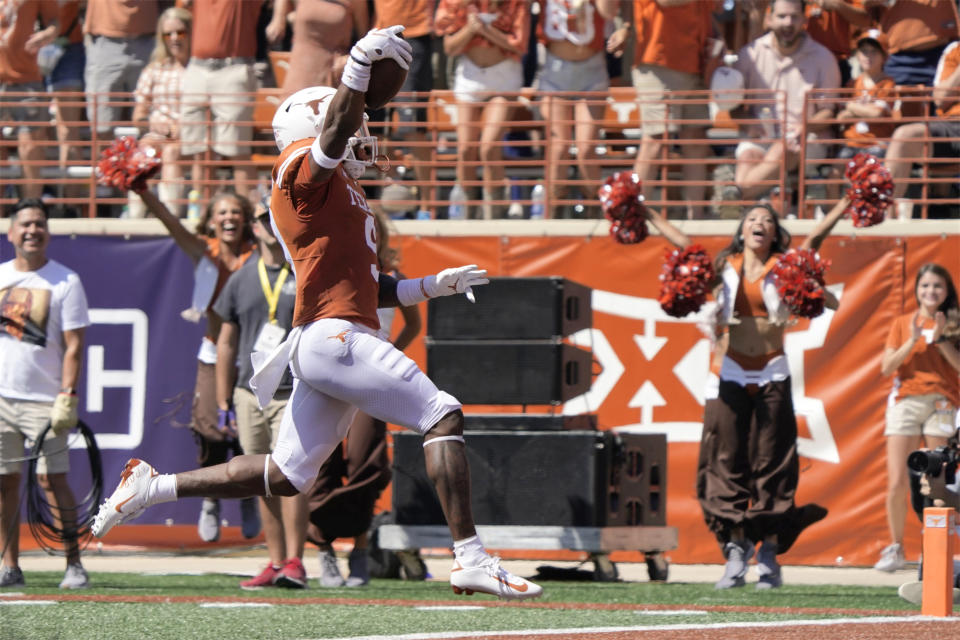 Texas defensive back Josh Thompson (9) celebrates as he returns an interception against Texas Tech for a touchdown during the first half of an NCAA college football game on Saturday, Sept. 25, 2021, in Austin, Texas. (AP Photo/Chuck Burton)