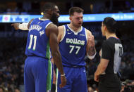 Dallas Mavericks forward Tim Hardaway Jr. (11) and guard Luka Doncic (77) argue a call with referee Evan Scott (78) in the first half of an NBA basketball game against the Detroit Pistons, Monday, Jan. 30, 2023, in Dallas. (AP Photo/Richard W. Rodriguez)