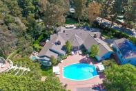 <p>The sprawling home sits on an acre of property, which includes gardens and a mosaic-tiled pool. (Sotheby’s International Realty) </p>