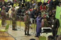 Riot police are deployed to provide security after scuffles broke out between political party agents and police at the electoral commission's national tallying center in Nairobi, Kenya, late night Saturday, Aug. 13, 2022. Kenya's peaceful presidential election saw a brief disruption late Saturday when police responded to scuffles at the national tallying center amid tensions over the close results. (AP Photo)